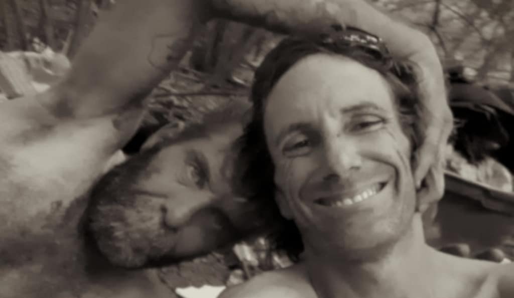 Black and white candid selfie of Sully and his close friend Paul smiling together outdoors, capturing a moment of brotherhood and community on the streets.